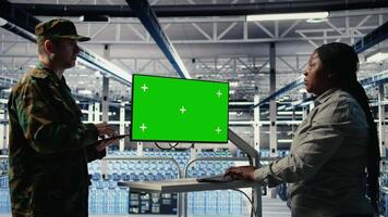 servidor habitación Ejército expertos desplegar ai tecnología en verde pantalla ordenador personal a modernizar defensa. militar servidor habitación colegas utilizando croma llave computadora a integrar artificial inteligencia tecnología, cámara un video