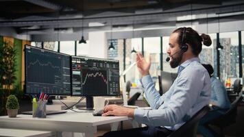 Investment consultant talking in headset mic, reviewing client portfolio performance. Trader discussing with customer, forecasting financial growth and providing tailored strategy, camera A video