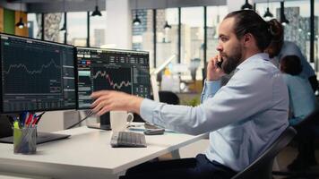 Financial advisor offers investment guidance during call with clients using smartphone. Investment consultant doing mobile phone call, helping customers build tailored portfolio, camera A video