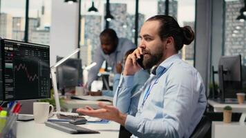 Financial advisor offers investment guidance during call with clients using smartphone. Investment consultant doing mobile phone call, helping customers build tailored portfolio, camera B video