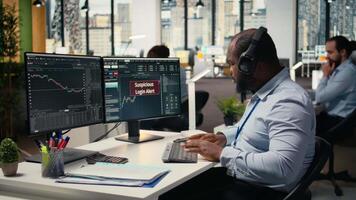 Trader in office spots suspicious login attempt warning on trading platform dashboard, working to fix error. Stockbroker seeing security alert notification of unauthorized login activity, camera A video