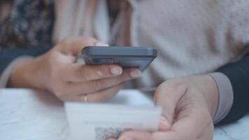 kvinna använder sig av en mobil enhet till skanna qr koda för Kafé meny video