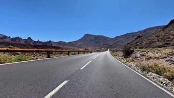 A Scenic Mountain Road Amidst Open Sky and Lush Landscape, Ideal for Adventure and Exploration photo