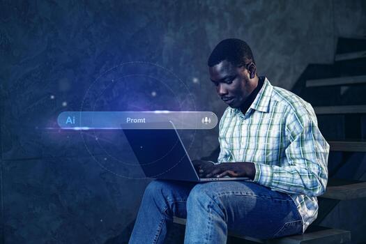 Man working on a laptop in a dimly lit space during an evening study session focused on artificial intelligence photo