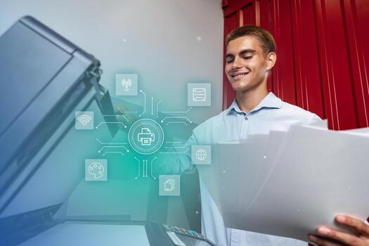 Young man using a printer in a modern office setting while managing documents and printing tasks photo