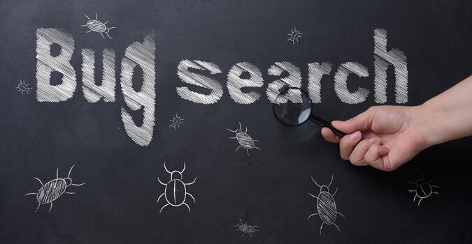 The process of finding and fixing bugs in software code. A person's hand holds a magnifying glass, using which to examine an inscription. photo