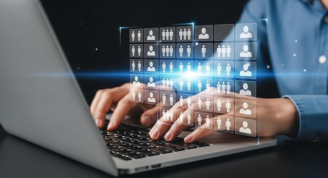 Close up of hands typing on a laptop keyboard with glowing digital data stream concept overlay photo