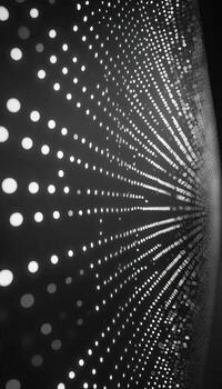 Abstract pattern of circular lights forming a dynamic radial design in monochrome photo