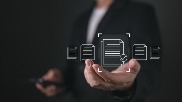 A person holds a smartphone while virtual icons of documents with a checkmark appear, symbolizing quality assurance, client focused services, and efficient document handling in a digital workflow. photo