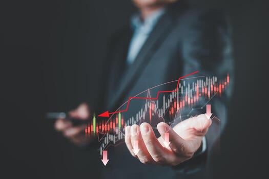 A businessman holds a smartphone with a digital graph displaying red trend lines, arrows, and bars representing a crisis in the global economy, highlighting recession signals on the chart. photo