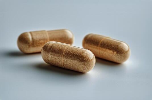 Capsules Resting on a Flat Surface With a Focus on Their Textured Appearance and Natural Color. photo