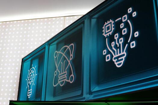 Digital display featuring illuminated icons symbolizing innovation, technology, and creativity. Glowing lightbulbs, gears, and circuitry represent the fusion of science and digital progress photo