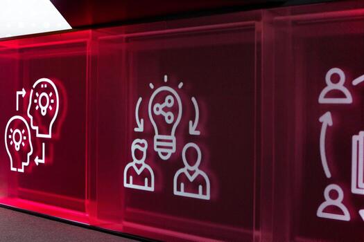 Digital screen displaying icons representing collaboration, innovation and idea sharing. Red background emphasizes exchange of thoughts, creativity and teamwork in modern business or tech environment photo