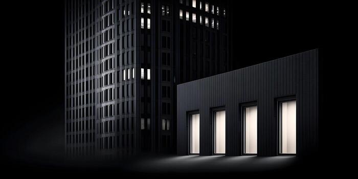 Three illuminated windows in a dark building at night with a tall building in the background photo