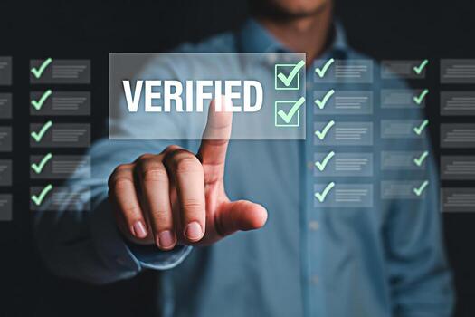 Verified status concept showing a hand touching a screen with checkmarks for approval and validation photo