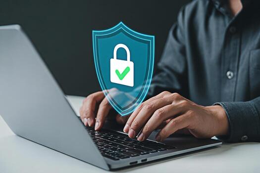 Cyber security concept man using laptop with shield and lock icon for data protection 100 character photo