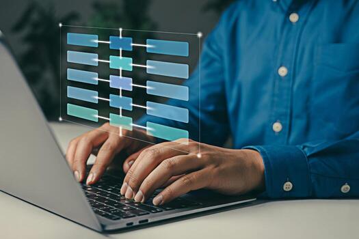 Man working on laptop with flowchart diagram for data analysis and project management planning task photo