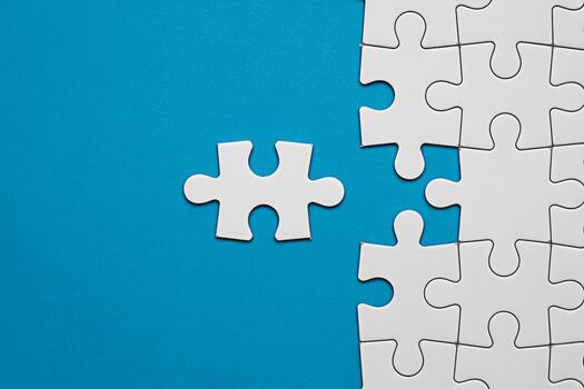 White jigsaw puzzle pieces on blue background concept for problem solving and teamwork solution idea photo