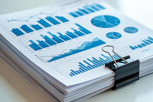 Business analytics report data charts diagrams and graphs financial analysis document with binder clip stack photo