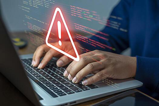 Computer security alert on laptop with hands typing for cybersecurity threat and data breach warning photo