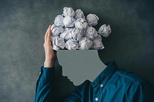 Concept of mental overload with crumpled paper head metaphor for stress and creative block brain fog 100 photo