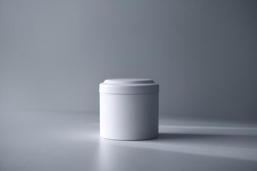 A minimalistic white container with a smooth lid, set against a soft, gray background. photo