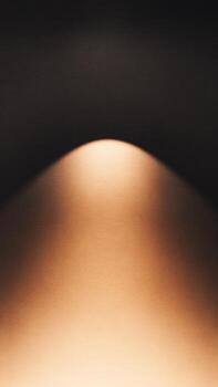 An abstract formation featuring a smooth gradient with a soft highlight, creating a minimalist aesthetic. photo