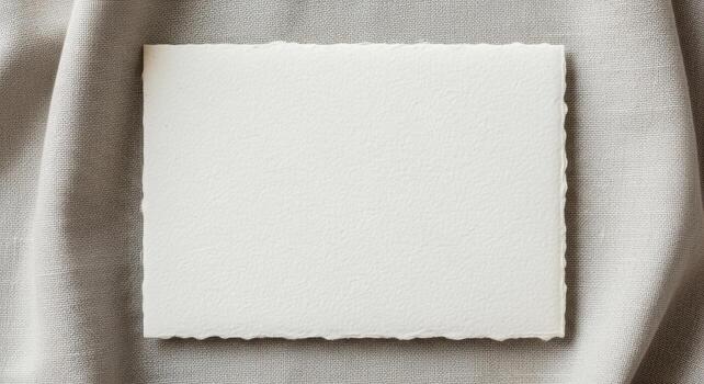 Blank Handmade Paper Card on Textured Fabric Background photo