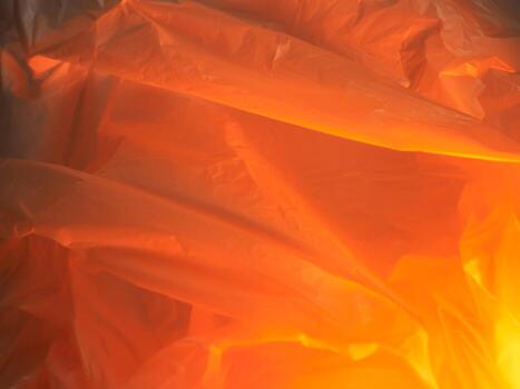 Orange plastic bag texture with water drops for abstract or environment background photo