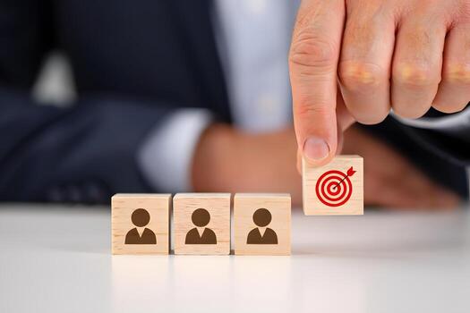 Hand Placing Target Block Above Team Blocks on Table photo