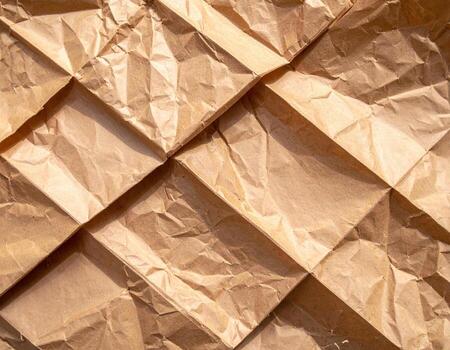 Crumpled paper background with a square pattern photo