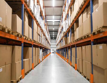 Large distribution warehouse filled with cardboard boxes on shelves, creating organized and efficient storage space photo