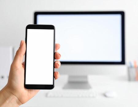 Hand holding smartphone with blank screen on white background photo