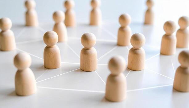 Wooden figurines represent vibrant human resource network, interconnected by lines symbolizing collaboration and communication. This evokes sense of community and teamwork photo