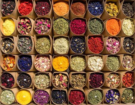 Vibrant array of spices and herbs displayed in paper tubes, showcasing kaleidoscope of colors and textures. Each container holds unique blends, inviting exploration and culinary creativity photo