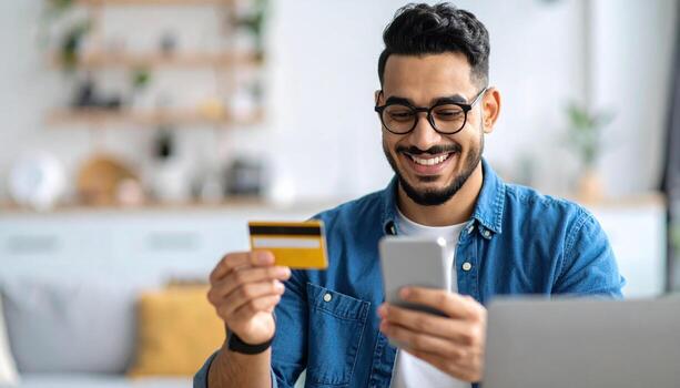 Man using credit card at home photo