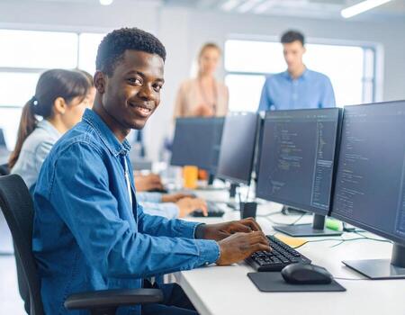 A young man is working on a computer photo