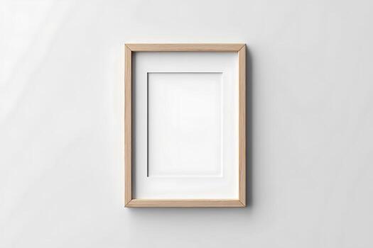 title A light colored wooden picture frame with a white mat and an empty rectangular space in photo
