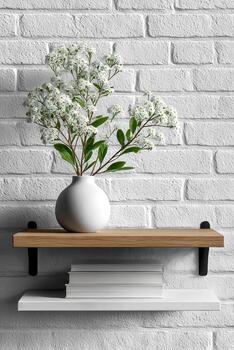 Flowers in vase on shelf against brick wall photo
