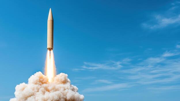 Rocket launch with smoke and flames against clear blue sky, showcasing power and technology photo