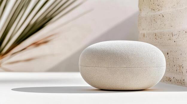 Compact wireless speaker with textured surface, placed white surface, surrounded by natural photo