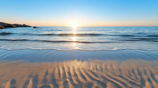 Tranquil beach at sunset with gentle waves and soft sand patterns photo