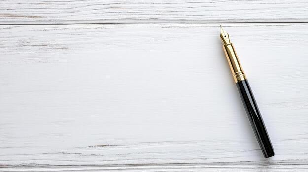 Elegant fountain pen with gold nib resting on white wooden surface, perfect for writing photo
