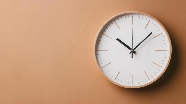 Minimalist wall clock design with white face and black hands against warm, textured background photo