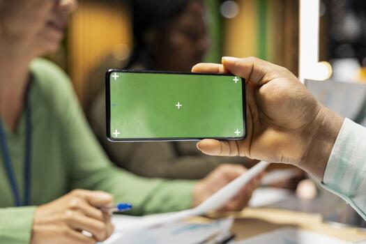Diverse team in a dark office shares insights and exchanges feedback, finalizing company agenda during a collaborative project briefing with global stakeholders. After hours discussion. photo