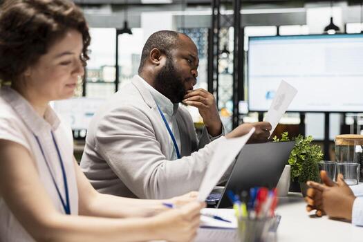 Diverse HR interviewers meeting with an applicant to review CV document, focusing on talent acquisition, work experience and qualifications for employment and onboarding process in enterprise. photo