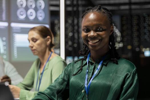 Smiling black executive assistant preparing a pitch for important meeting, increasing funds for development after hours. Coworkers team attend a discussion to address goal setting. photo