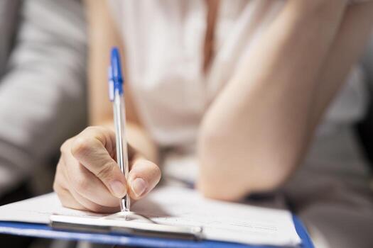 Close up of candidate filling in registration forms for job application and interview, ensuring a great recruitment process and successful meeting with the HR. Writes down qualifications. photo