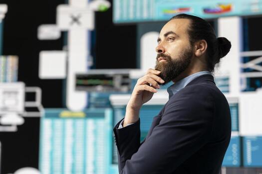 Company administrator thinking about a new decision for business development, working hard for success while he analyzes all reports and performance metrics. Wishing long term growth. photo