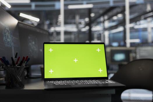 Close up of isolated screen laptop on desk in data center overseeing supercomputers required for artificial intelligence systems. Mockup notebook in office used for monitoring server room gear photo